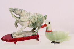 A Chinese jade or similar hardstone carving of a Tang style horse with raised foreleg,