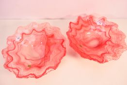 A pair of Lavorazione Arte Murano glass centrepieces or bowls in an opaque pink glass and having
