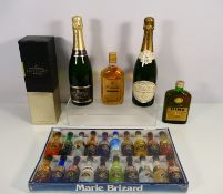 A Marie Brizard liqueur set of twenty miniatures, two bottles of champagne,