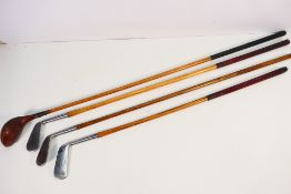Four hickory shaft golf clubs comprising a Rustless Special putter, Rustless Special 1 iron,