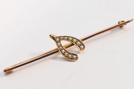 A yellow and rose metal (stamped 9) bar brooch with split pearl set wishbone motif, 6.