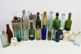 A quantity of vintage glass bottles to include B Cunningham, Warrington, W T Wigg & Co, Warrington,