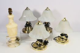 Four table lamps with marbled glass shades, approximately 26 cm (h) and a onyx style table lamp.