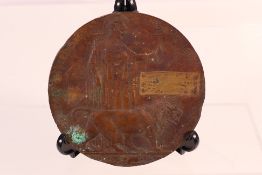 A World War One (WW1 / WWI) bronze memorial plaque, in poor condition with name erased.