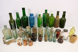 A quantity of vintage stoneware and glass bottles, jugs and vessels to include Peter Walker & Son,