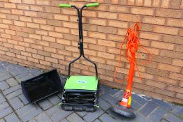 Lot to include a The Handy manual lawn mower and a Flymo Mini Trim. [2].