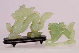 Two Chinese jade or similar hardstone figures of dragons, largest approximately 12 cm (l),
