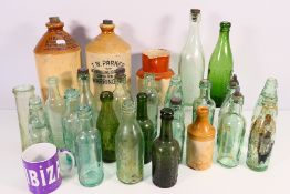 A collection of vintage glass bottles to include Codd-neck examples for C Ammack & Co,