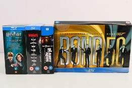 Four Blu-ray box sets comprising Planet Of The Apes Evolution Collection, Bond 50,