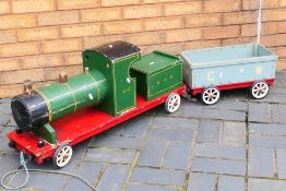 A scratch built wooden train with carriage.