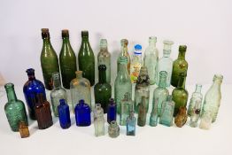 A collection of vintage glass bottles to include Boot's Cash Chemist, Codd-neck example,