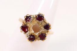 A 9ct yellow gold cluster ring (lacking central stone),
