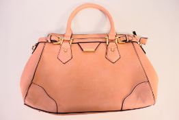 A handbag in salmon with gold coloured detail,