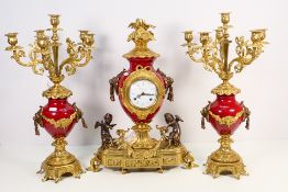 A gilt metal and enamel clock garniture,