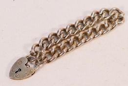 A silver bracelet and heart shaped padlock clasp, 19 cm, approximately 54 grams.