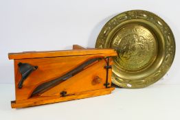 A butcher's vintage meat slicer and a brass charger, approximately 46 cm (d). [2].
