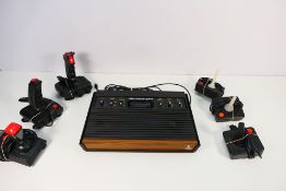 Atari - Spectravideo - SVI - Delta - A vintage Atari CX 2600 U console with a group of joystick