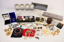 A collection of costume jewellery comprising brooches, necklaces, pendants, cufflinks,