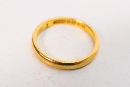 A 22ct gold wedding band, size N, approximately 3.6 grams.