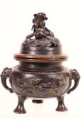 A small cast metal censer and cover with twin elephant mask handles,