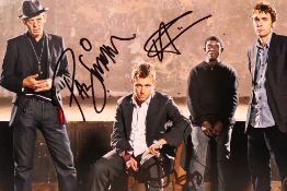 A signed photographic image of the band The Good, The Bad & The Queen, signed by all four members,