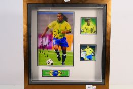 A signed photographic display depicting Ronaldinho, in display frame,