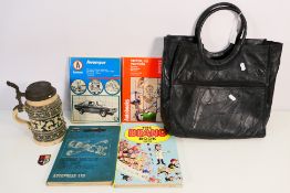 Lot to include a German stoneware stein, a handbag, car maintenance books and a 1972 Beano Book.