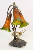 A three stem table lamp with Angels Trumpet form shades, approximately 40 cm (h).