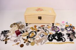 A painted wooden jewellery casket containing a quantity of costume jewellery to include bangles,
