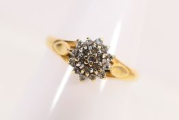 An 18ct yellow gold diamond cluster ring, size N+½, approximately 2.5 grams.
