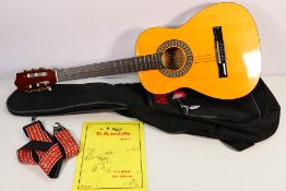 An Encore acoustic guitar, model ENC34, contained in Rok Sak guitar bag.
