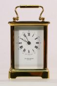 A lacquered brass carriage timepiece, enamel dial signed Taylor & Bligh, England,