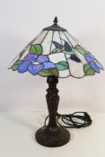 A Tiffany style table lamp, the shade with kingfishers and flowers, approximately 55 cm (h).