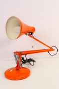 An Anglepoise lamp, model 90, in orange colourway with circular weighted base,