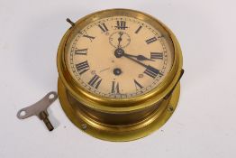 A brass cased bulkhead clock,