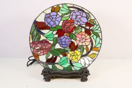 A Tiffany style lamp with circular floral decorated shade, approximately 38 cm (d).