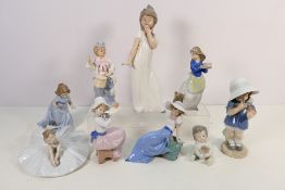 A collection of nine unboxed Nao and similar figures, predominantly depicting young girls,