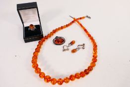 An amber bead necklace of 59 graduated beads, smallest approximately 6 mm (d) and largest 12 mm (d),