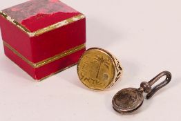 A 10 Argorot coin in yellow metal mount,