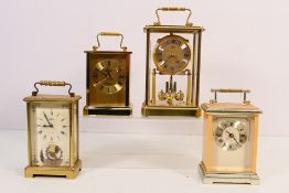 Three carriage style timepieces including a Schatz 8 Day and one other.