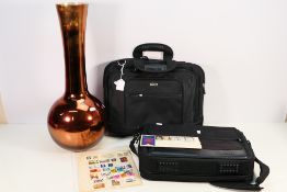 A large glass vase, approximately 60 cm (h), a small quantity of stamps and two Targus laptop bags.