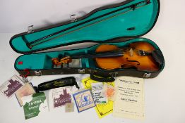 A Lark violin contained in hard case with bow and further accessories.