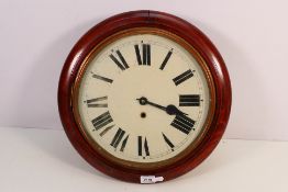 A circular wall clock with Roman numerals to a 12