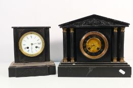 Two black slate mantel clocks, one of architectural form, Roman numerals to each dial,