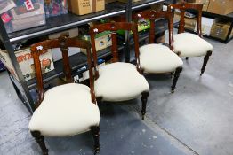 A set of four oak framed chairs with carved back rest,