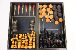 A vintage backgammon and chess set, of folding book form with two dice cups,