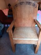 An oak open armchair with carved decoration of fruiting vine, 100 cm to top of backrest.