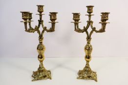 A pair of decorative brass candelabra, each of five lights, approximately 38 cm (h). [2].