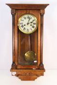 An oak cased mantel clock with key and pendulum, 74 cm (l).