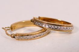 A pair of 9ct two-tone ear hoops, 2.5 cm (l), approximately 2.1 grams.